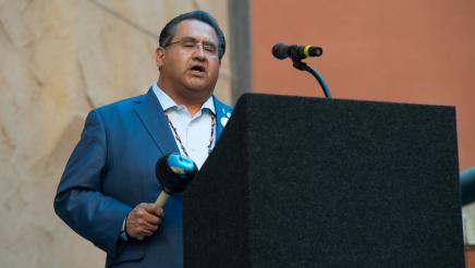 Assemblymember Ramos standing at the podium blessing the Missing Murdered Indigenous Peoples Reception
