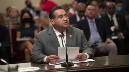 Assemblymember James Ramos standing behind a podium speaking at a press conference for AB 1314