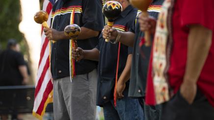 Group of men playing native american instruments at the Third Annual California Indian Cultural Awareness Event