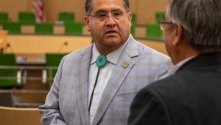 Assemblymember Ramos talking to attendee at the Select Committee on Native American Affairs