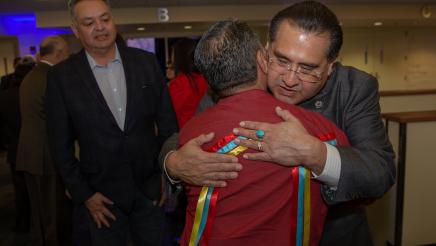 Assemblymember James C. Ramos hugging his brother Ken Ramirez